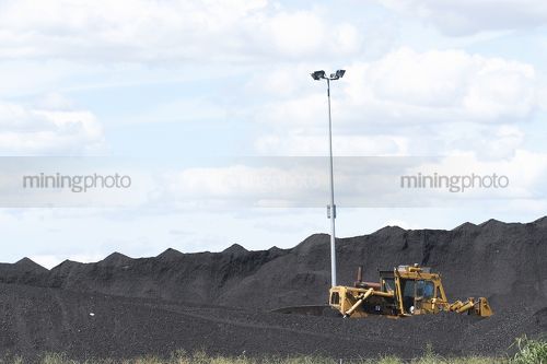 Coal stockpile with dozer - Mining Photo Stock Library
