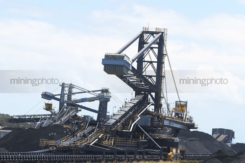 Reclaimers, loaders and conveyors with stockpiles of coal. - Mining Photo Stock Library