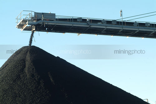 Moving conveyor loading coal onto stockpile - Mining Photo Stock Library