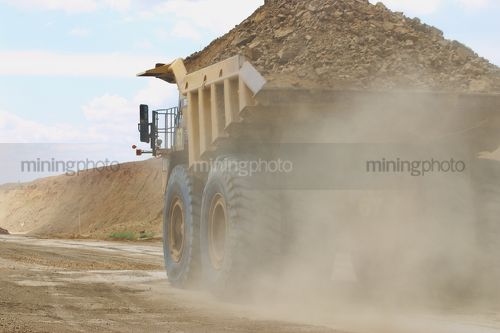 Haul truck loaded with overburden in the pit of an open cut coal mine.   - Mining Photo Stock Library
