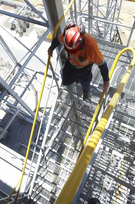 Mine worker safely using 3 points of contact on stairs - Mining Photo Stock Library