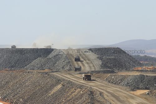 Haul trucks on dump circuit at open cut mine. - Mining Photo Stock Library