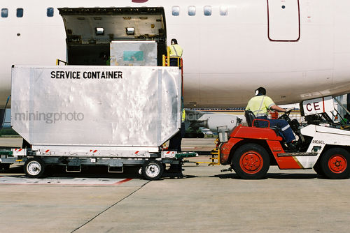 Loading plane containers at the airport - Mining Photo Stock Library