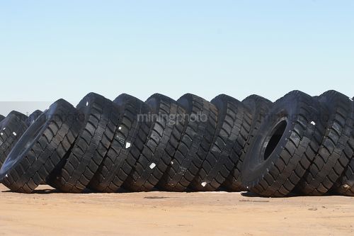 Stockpile of haul truck tyres at open cut mine site. - Mining Photo Stock Library
