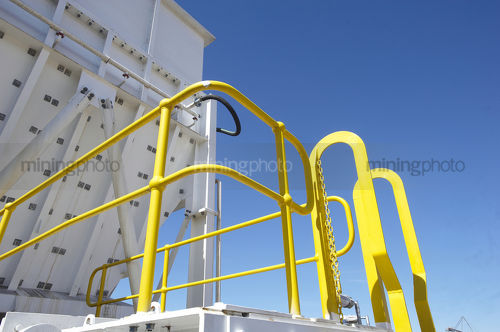 Yellow painted steelwork around hopper.  this is the required mine safety colour paint. - Mining Photo Stock Library