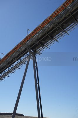 Overhead coal conveyor shot from underneath.  production. vertical shot. - Mining Photo Stock Library