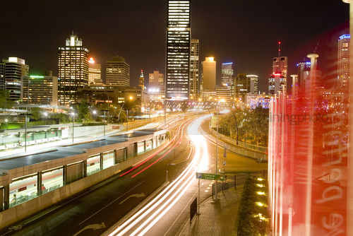 Flow of car traffic lights at night leading into the city - Mining Photo Stock Library