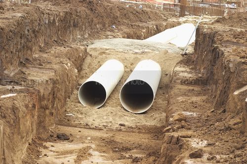 Drainage water pipes in pit at construction  site. - Mining Photo Stock Library