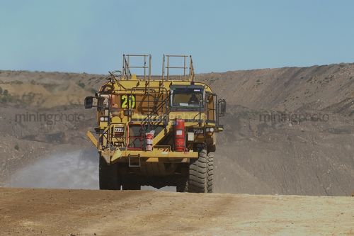 Water truck spraying for dust suppression on haul road at open cut coal mine. - Mining Photo Stock Library