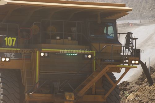 Close up of a 785 haul truck  clearly showing green LED lights on the front. - Mining Photo Stock Library