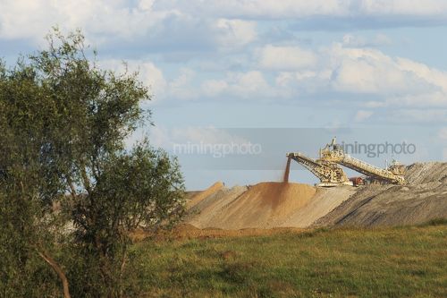 Overburden spreader working on open cut mine.  stockpile overburden around. - Mining Photo Stock Library