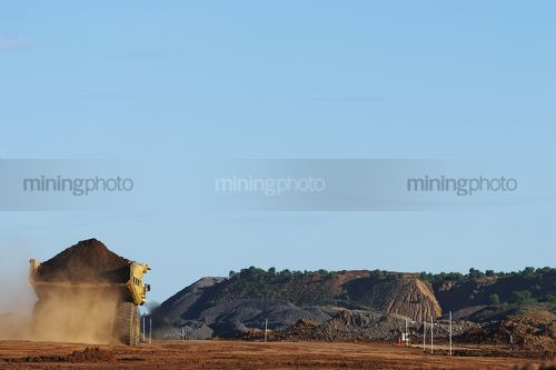 Loaded haul truck moving on haul road in open cut mine - Mining Photo Stock Library
