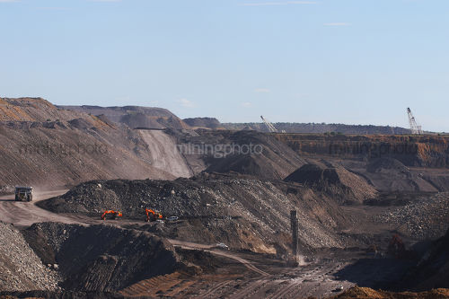 Wide open cut mine shot showing haul truck, drill drilling blast holes, excavators and two draglines. - Mining Photo Stock Library