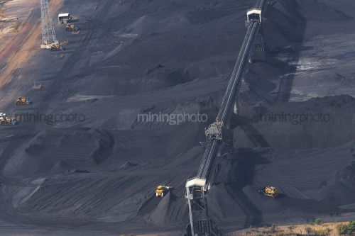 Tractors stockpiling coal at ship terminal.  - Mining Photo Stock Library