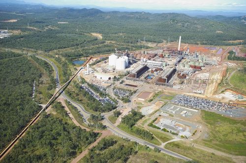 Aerial photo of a bauxite and alumina refinery.  wide shot showing plant and conveyor system from shippng wharf. - Mining Photo Stock Library