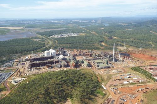 Aerial shot of bauxite and alumina refinery with township in background. - Mining Photo Stock Library