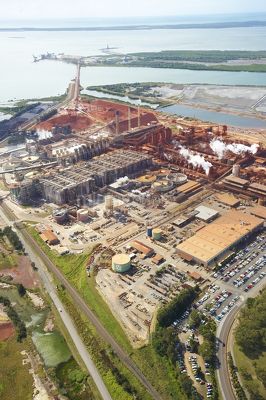 Vertical wide aerial photo of a bauxite alumina refinery.  clearly depicts wharf shipping and all areas of processing plant. - Mining Photo Stock Library