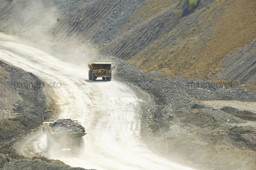 Two haul trucks on haul road in open cut coal mine. - Mining Photo Stock Library