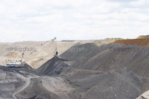 Wide photo of dragline working to remove overburden in open cut coal mine - Mining Photo Stock Library