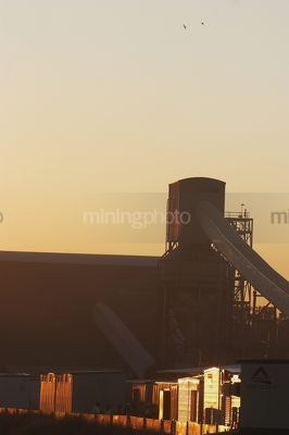 Workers meeting at first light with coal wash plant and conveyors in background. - Mining Photo Stock Library