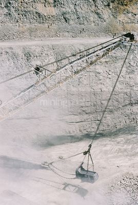 Vertical closeup photo of dragline moving overburden in open cut coal mine - Mining Photo Stock Library