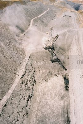 Vertical aerial photo of dragline moving overburden in open cut coal mine. access roads - Mining Photo Stock Library