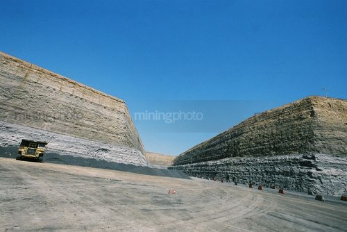 Wide photo of safety barricades and high wall at open cut coal mine. - Mining Photo Stock Library