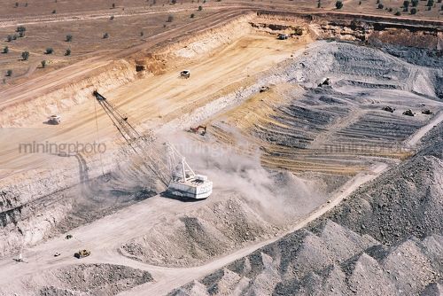 Great aerial shot showing all forms of overburden removal in an open cut coal mine.  dragline, excavator and truck rotation, dozer push - Mining Photo Stock Library