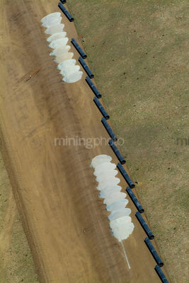 Vertical aerial of domestic water supply pipes and sand ready for crane to assemble - Mining Photo Stock Library