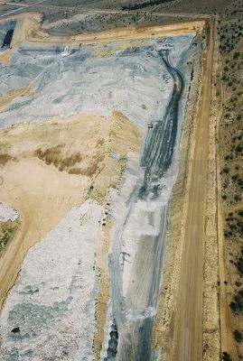 Aerial photo of overburden stock piling in open cut coal mine.  excavator and truck rotation and dragline in background. mine access haul roads adjacent. - Mining Photo Stock Library