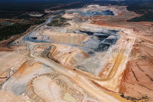 Great wide aerial photo of excavator loading overburden into haul trucks in open cut coal mine. - Mining Photo Stock Library