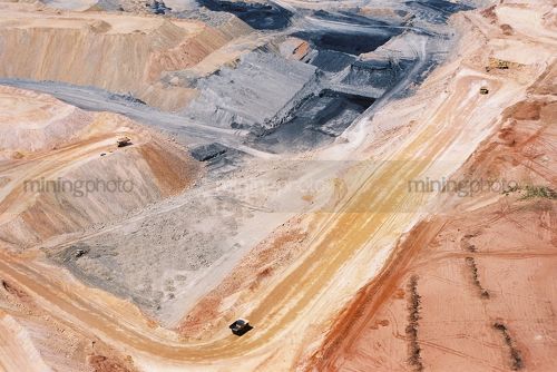 Wide aerial shot of haul trucks on haul road in open cut coal mine. - Mining Photo Stock Library