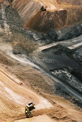 Vertical aerial photo of excavator loading over burden into haul truck in open cut coal mine. - Mining Photo Stock Library