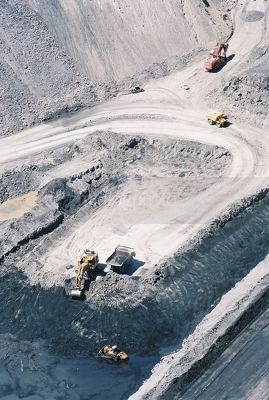 Wide aerial vertical photo of excavator loading coal into haul trucks in open cut coal mine. - Mining Photo Stock Library