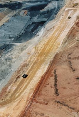 Wide aerial shot of two haul trucks on haul road in open cut coal mine. - Mining Photo Stock Library
