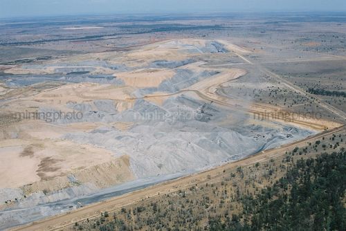 Wide aerial photo of dragline working in open cut coal mine in the middle of nowhere.  rehabilitation in foreground, remote open landscape in background. - Mining Photo Stock Library