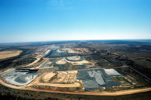 Wide aerial photo of working open cut coal mine in remote environment. - Mining Photo Stock Library