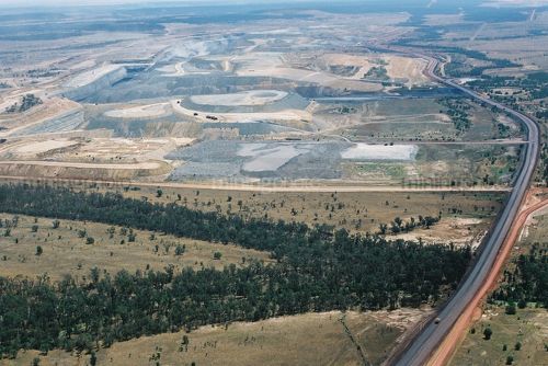 Long haul access road in open cut coal mine.  shot very wide and aerial. - Mining Photo Stock Library