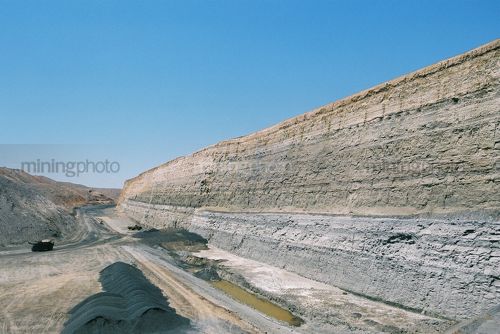 Haul truck on haul road in open cut coal mine.  large high walls with coal sema adjacent. - Mining Photo Stock Library