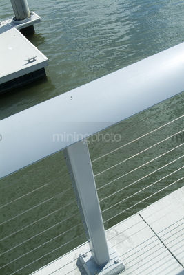 Handrail in foreground with river pontoon and water in background - Mining Photo Stock Library