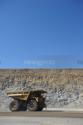 Generic vertical shot of a coal haul truck in open cut mine. blue sky and high walls behind.
truck carrying overburden. - Mining Photo Stock Library