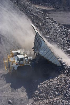 Aerial photo of haul truck dumping overburden at dump site in open cut mine. - Mining Photo Stock Library