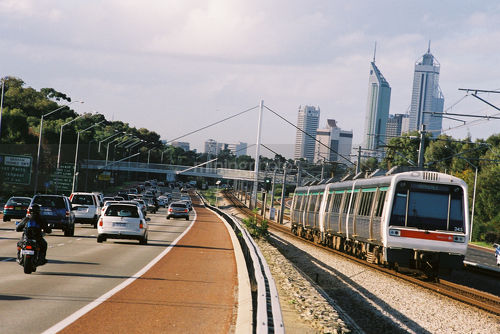 Cars and train take commuters in peak hour into Perth city. - Mining Photo Stock Library