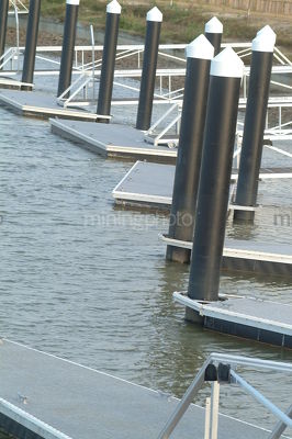 Marina pilons and jetty's in canal property subdivision.  pontoon - Mining Photo Stock Library