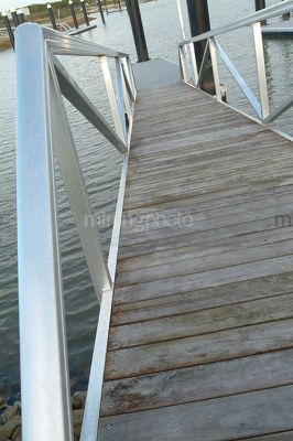 Bridge down to pontoon jetty in waterfront  property subdivision - Mining Photo Stock Library