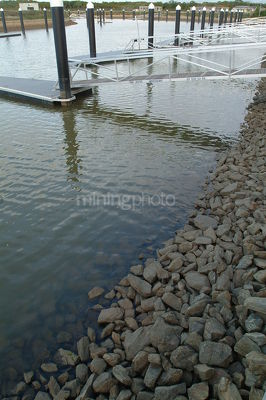 Looking across jettys and pontoons in waterfront property canal  - Mining Photo Stock Library