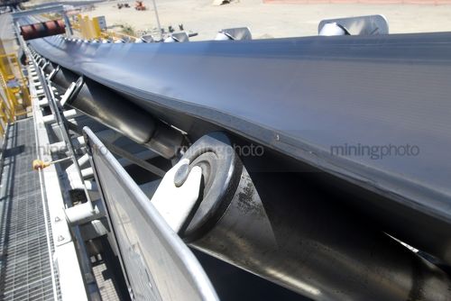 Close up photo of a conveyor at a mine site. - Mining Photo Stock Library
