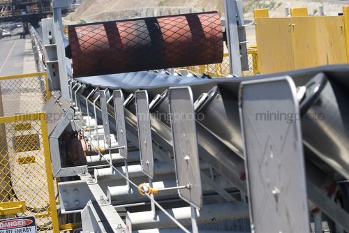 Close up of a new coal conveyor at a coal terminal.  could be a conveyor in any mine. - Mining Photo Stock Library