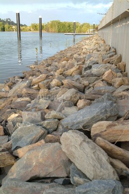 Rock wall in canal waterfront property subdivision - Mining Photo Stock Library