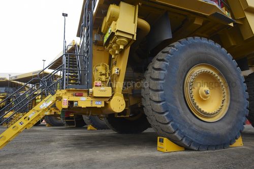 Close up photo of new komatsu haul trucks parked at the go line in open cut coal mine. - Mining Photo Stock Library